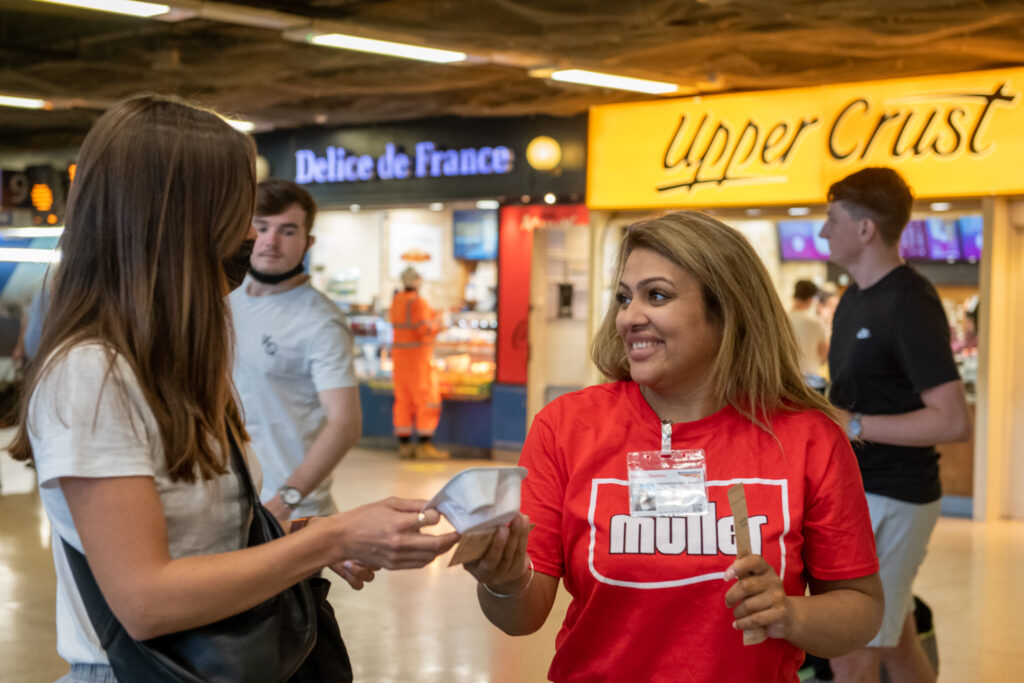 Promotional event staff handing our product samples in tube station 