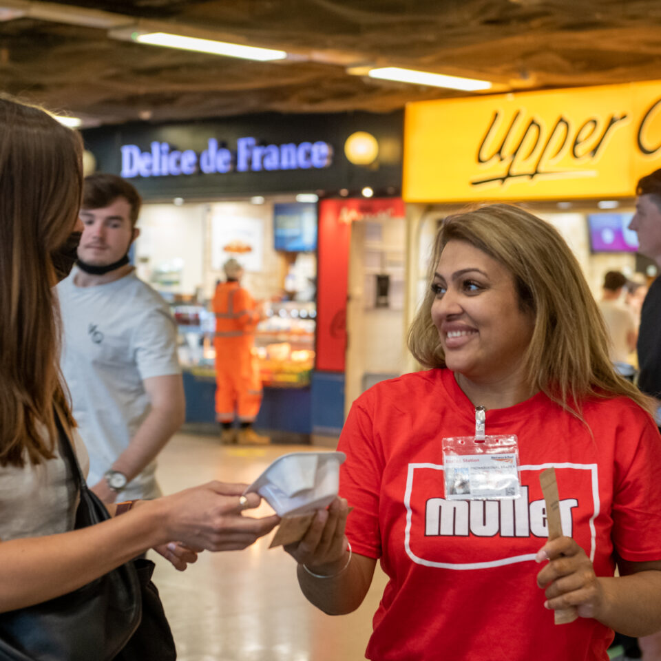 Promotional event staff handing our product samples in tube station